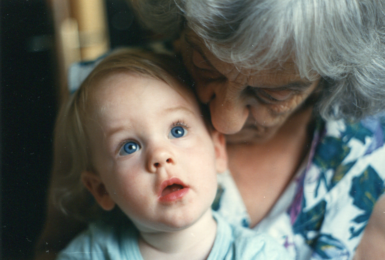 Kleinkind und Uroma kuscheln